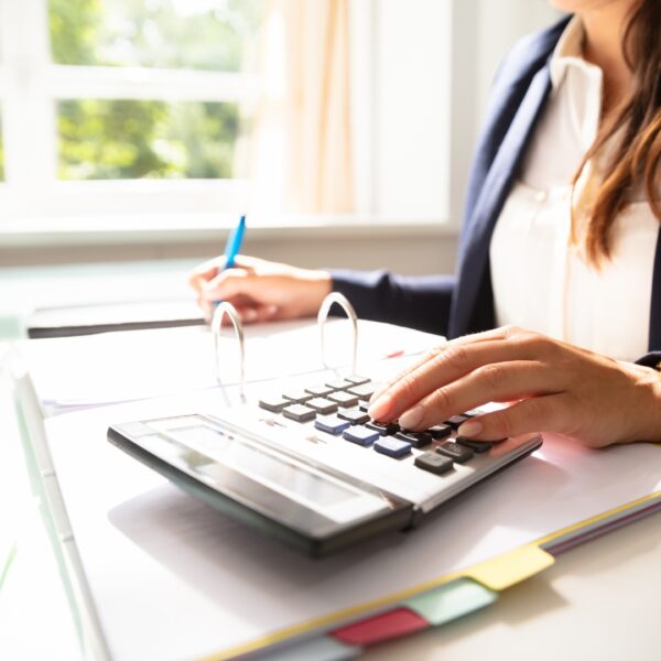 woman using calculator on desk