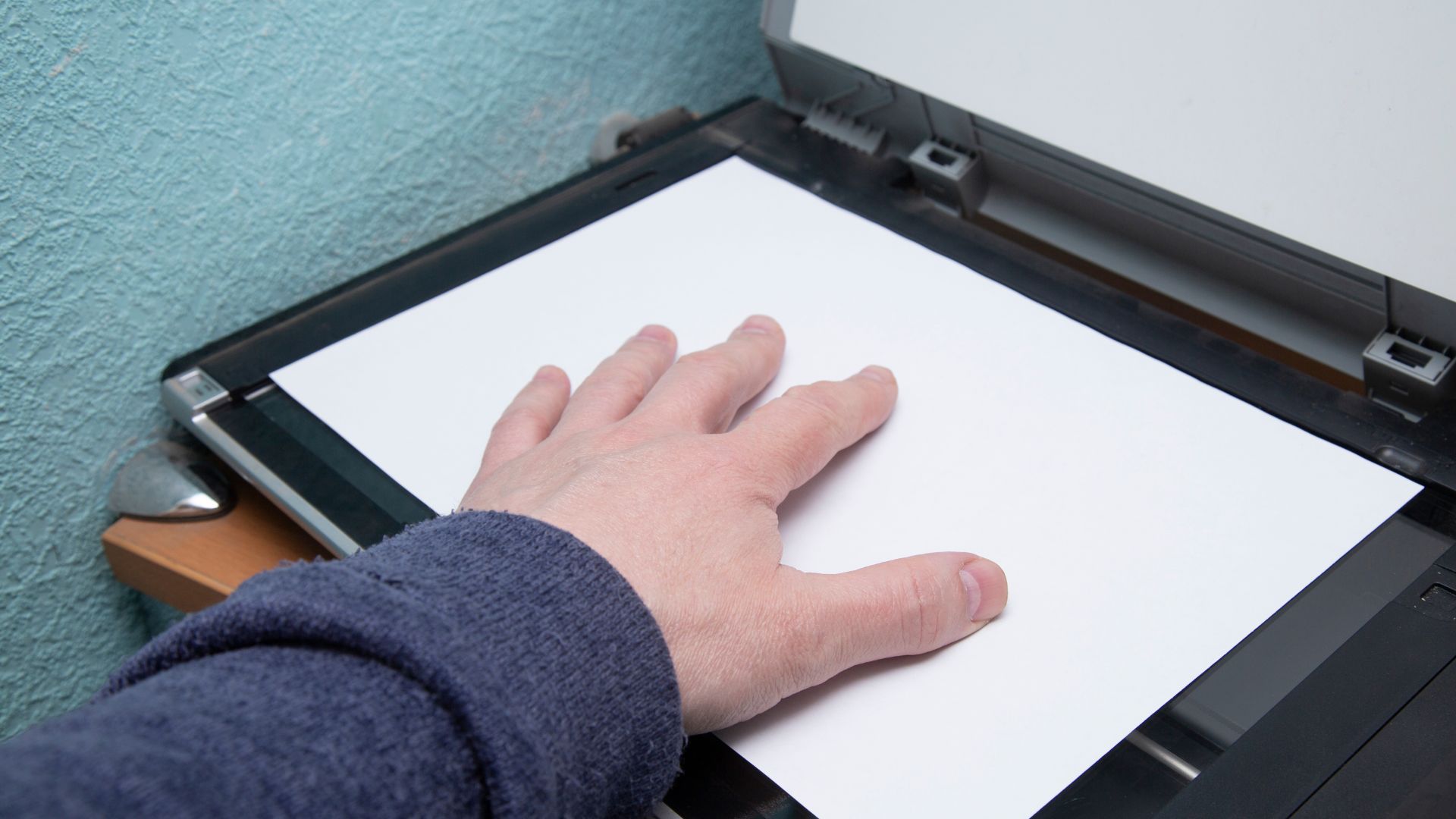 placing a piece of paper on a scanner