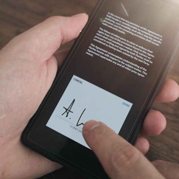Person leaving an e-signature on mobile phone